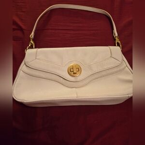 Very cute, small cream purse with a short handle. Never used. Great, clean shape